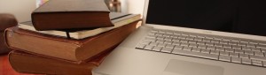 Book pile and laptop